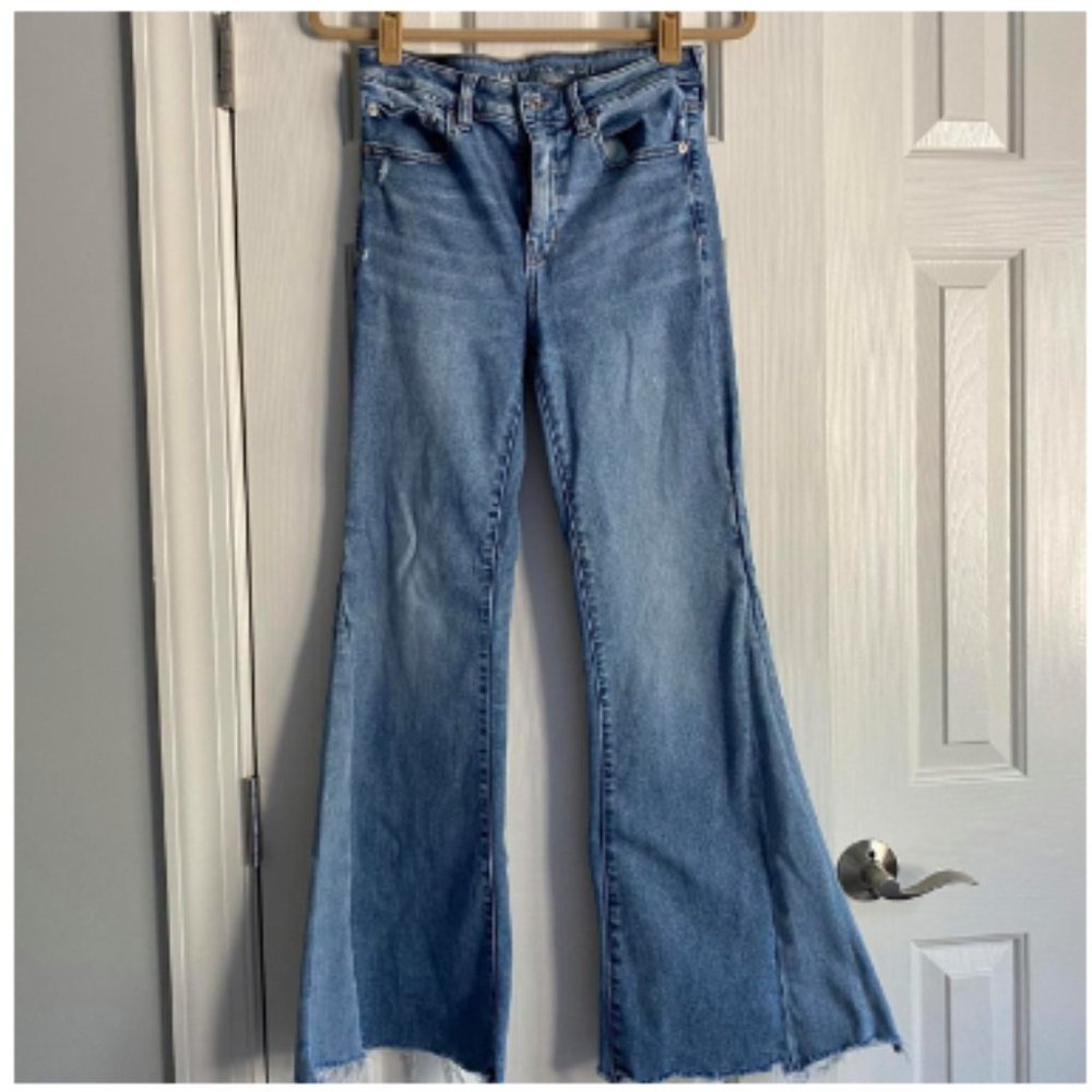 light wash flared jeans with ripped details